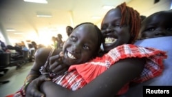 South Sudanese waiting to be flown back to their country sit at Khartoum Airport May 14, 2012. 