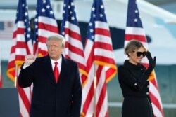 FILE - Then-President Donald Trump and then-first lady Melania Trump wave to supporters at Andrews Air Force Base, Md., Jan. 20, 2021.