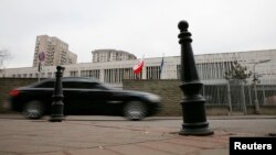 A car drives past a building of the Polish Embassy in Moscow, Nov. 17, 2014. 
