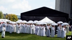 Catholic faithful attend the beatification ceremony of Polish Cardinal Stefan Wyszynski and Mother Elzbieta Roza Czacka in front of the church of Providence in Warsaw, Poland, Sept. 12, 2021.