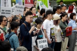 Taiwanese people gather to support Hong Kong people as the administration prepares to open debate on a highly controversial extradition law, in front of Hong Kong Economic, Trade and Culture Office in Taipei, Taiwan, June 12, 2019.