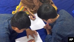 This September 2021 photo provided by their mother shows three children in Afghanistan. Every night, their father, a US green card holder from California, and his wife take turns sleeping, with one always awake so they can flee the Taliban.