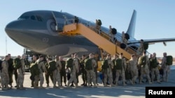 FILE - Canadian Armed Forces members from 4 Wing Cold Lake, Alberta, depart for their deployment, Oct. 22, 2014. Canada will end its airstrikes against Islamic State targets in Iraq and Syria this month.