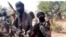 Members of a "bandit" gang pose with weapons at their forest hideout in northwestern Zamfara state, Nigeria, Feb. 22, 2021. 