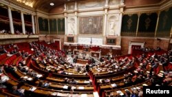 FILE - A general views shows the hemicycle as French Prime Minister Manuel Valls delivers a speech during a parliamentary debate on Iraq at the National Assembly in Paris, Sept. 24, 2014. 