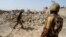 FILE - Pakistani soldiers stand near debris of a house which was destroyed during a military operation against Islamist militants in the town of Miranshah, North Waziristan, Pakistan, July 9, 2014. 