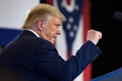 President Donald Trump pumps his fist as he finishes speaking during an event at the Whirlpool Corporation facility in Clyde, Ohio, Thursday, Aug. 6, 2020.