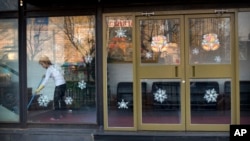FILE - In this Feb. 17, 2016 photo, a worker sweeps the floor inside a branch of the North Korean-operated Haedanghwa restaurant in Beijing. Chinese news reports, Sept. 28, 2017, say the government has ordered most North Korean-owned businesses and ventures with Chinese partners to close under U.N. sanctions imposed over the North's nuclear and missile programs. 