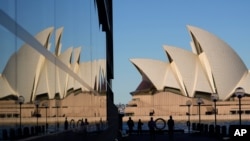 People walk around the waterfront of at Campbell Cove in Sydney, Australia, May 19, 2021. 