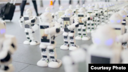 Robots are seen waiting in line for a new iPhone in New Zealand. (Spark)