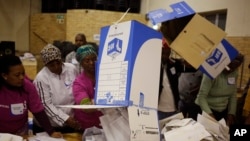 Election officials start the ballot-counting process at a polling station during municipal elections in Manenberg on the outskirts of Cape Town, South Africa, Aug. 3, 2016. 