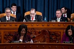 House Judiciary Committee Chairman Rep. Jerrold Nadler, D-N.Y., center, announces the adjournment, as ranking member Doug Collins, R-Ga., right, looks on following a marathon debate.