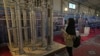 FILE -A student looks at Iran's domestically built centrifuges in an exhibition of the country's nuclear achievements, in Tehran, Feb. 8, 2023.