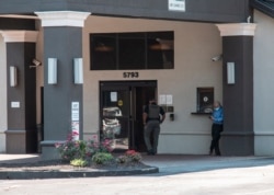FILE - A member of the Fulton County Sheriff's Office, center, walks into the Comfort Inn Sandy Springs - Perimeter hotel, where Iran set up a station for its citizens to vote in its presidential election, June 18, 2021, in Atlanta.