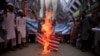 FILE - Supporters of the Jamaat-ud-Dawa Islamic organization burn a mock U.S. flag during a protest in Peshawar, Pakistan, May 27, 2016.