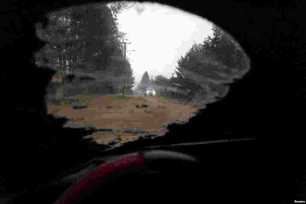 A vehicle travels along a road at Pucon city, Chile, which was hit by ashes from Calbuco volcano, April 23, 2015