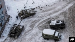 FILE - Ukrainian tanks stand in the yard of an apartment block in Avdiivka, eastern Ukraine, Feb. 1, 2017. 