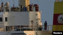 People with weapons stand on board the Maltese-flagged bulk cargo vessel Ruen seized by Somali pirates, which was intercepted by the Indian navy at sea, in this handout photo released on March 16, 2024. (SpokespersonNavy via X via Reuters)