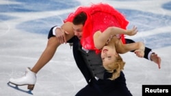Russia's Ekaterina Bobrova (top) and Dmitri Soloviev compete during the figure skating ice dance short dance program at the Sochi 2014 Winter Olympics Feb. 16, 2014.