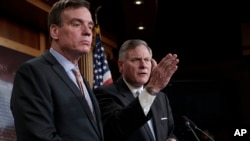 Sen. Mark Warner, D-Va., left, the vice chairman of the Senate Select Committee on Intelligence, and Chairman Richard Burr, R-N.C., right, speak to reporters about their panel's investigation of Russian interference in the 2016 election, on Capitol Hill, March 29, 2017.