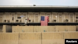 A U.S. flag is displayed at a military housing unit inside of Bagram Air Field, Parwan province of Afghanistan, Jan. 2, 2015. The continued U.S. presence there has gotten little attention in the presidential campaign back home.