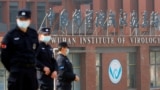 Security personnel keep watch outside the Wuhan Institute of Virology