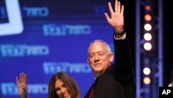 Blue and White party leader Benny Gantz and his wife Revital wave to supporters at party headquarters after the first results of the elections in Tel Aviv, Israel, Sept. 18, 2019. 
