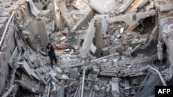 A man inspects the damage following an Israeli strike on a home in the al-Daraj neighborhood in Gaza City, in the central Gaza Strip on Dec. 19, 2024.