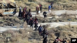 FILE - This Nov. 27, 2016 photo provided by the Rumaf, a Syrian Kurdish activist group, which has been authenticated based on its contents and other AP reporting, shows people fleeing rebel-held eastern neighborhoods of Aleppo into the Sheikh Maqsoud area that is controlled by Kurdish fighters in Syria.