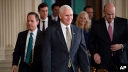 FILE - Vice President Mike Pence, center, arrives in the East Room of the White House in Washington, Feb. 13, 2017.
