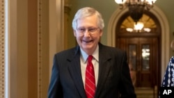 Senate Majority Leader Mitch McConnell, R-Ky., smiles after vote on a hard-won budget deal that would permit the government to resume borrowing to pay all of its obligations and would remove the prospect of a government shutdown in October, at the…