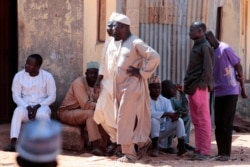 FILE- Parents gather at the Government Science school where gunmen abducted students, in Kankara, in northwestern Katsina state, Nigeria, Dec. 14, 2020.