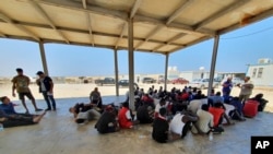 Rescued migrants rest near the city of Khoms, around 120 kilometers (75 miles) east of Tripoli, Libya, Aug. 27, 2019.