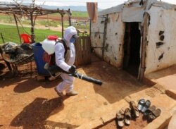 A worker from the municipality sanitizes Syrian refugee camp, as Lebanon extends a lockdown to combat the spread of coronavirus disease (COVID-19) in Marjayoun, Lebanon, March 23, 2020.