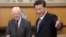FILE - Then-leader of China's Communist Party of China Xi Jinping, right, gestures to former U.S. President Jimmy Carter during their meeting at the Zhongnanhai, the central government compound in Beijing, China, Dec. 13, 2012. (China Daily via Reuters)