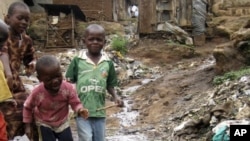 Children play near a punctured water pipe in Nairobi's Kibera slums (File Photo)