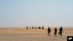 Three men head north towards Algeria after crossing the Assamaka border post in northern Niger, June 3, 2018.
