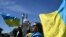 Activists wave Ukrainian flags outside the U.S. Capitol in Washington, DC, on April 23, 2024, ahead of a U.S. Senate vote on a foreign aid package which included $61 billion in assistance for Ukraine. (Mandel Ngan/AFP)