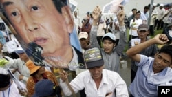 Cambodian supporters of Mam Sonando, one of Cambodia’s most prominent human rights defenders, protest in front of the Phnom Penh Municipal Court, in Phnom Penh, Cambodia, Monday, Oct. 1, 2012. Some 300 supporters gathered to demand the release of local radio station owner Mam Sonando, who is accused of leading a secession, file photo. 