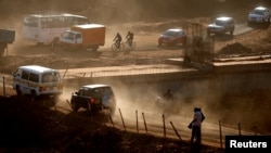 People and vehicles are seen on a road under construction in Nairobi, Kenya, Jan. 25, 2017.