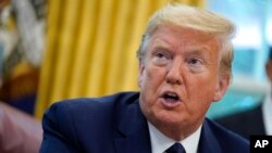 FILE - In this May 28, 2020 file photo, President Donald Trump speaks as he receives a briefing on the 2020 hurricane season in the Oval Office of the White House in Washington. The United States is out of the Paris climate agreement on the day after the 