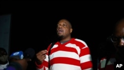 Zimbabwe journalist Hopwell Chin'ono talks to the press following his release from prison in Harare, Sept. 2, 2020.