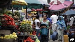 Women sell vegetables and other food in a market on World Food Day in Lagos, Nigeria, Tuesday, Oct. 16, 2012. One in eight people around the world goes to bed hungry every night, according to the United Nations.