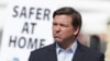 Florida Gov. Ron DeSantis listens during a news conference at a drive-through coronavirus testing site in front of Hard Rock Stadium, Monday, March 30, 2020, in Miami Gardens, Fla. Gov. Ron DeSantis doesn't want the people on the Holland America's…