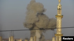 Smoke rises after a Syrian Air Force fighter jet loyal to Syria's President Bashar al-Assad fired missiles at Deraa November 4, 2012.