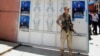 FILE - An Iraqi Turkoman fighter stands guard outside the Iraqi Turkmen Front headquarters in Kirkuk, Iraq, June 16, 2014.
