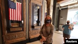 Laura Cohen, 62, waits in line to vote at the Pantages Theater, during the global outbreak of the coronavirus disease (COVID-19), in Hollywood, Los Angeles, California, Oct. 30, 2020. 