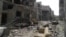 A view shows debris along a street of damaged buildings by what activists said was shelling by forces loyal to Syria's President Bashar al-Assad in Homs, Apr. 8, 2013. 