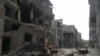 A view shows debris along a street of damaged buildings by what activists said was shelling by forces loyal to Syria's President Bashar al-Assad in Homs, Apr. 8, 2013. 