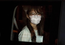 Pro-democracy activist Agnes Chow Ting is arrested from her home in Hong Kong, Aug. 10, 2020.